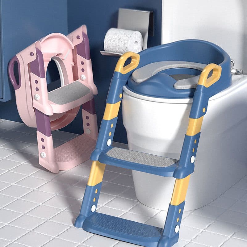 A blue and yellow potty training ladder seat set up on an adult toilet, beside a folded pink version resting against the bathroom wall.