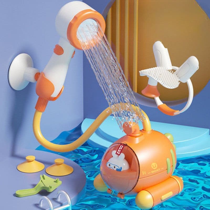 An orange radish-shaped submarine bath toy in water connected by a yellow hose to a shower head spraying water against a wall.