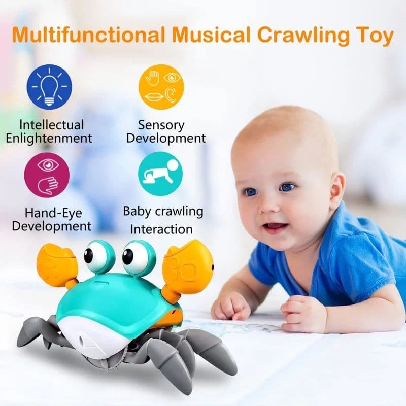 A colorful plastic toy crab with teal shell, orange claws, and large eyes sitting on a light surface near a baby on their tummy.